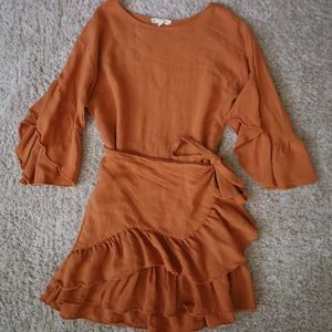 Size: med but fits small. Orange rust mini dress.
